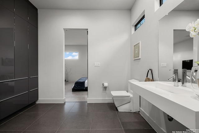 bathroom featuring tile patterned floors, toilet, and sink