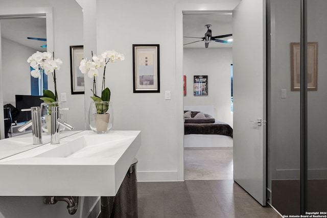 bathroom with ceiling fan, sink, and concrete flooring