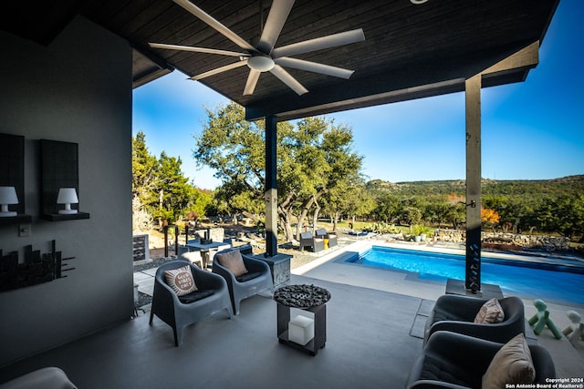 view of pool featuring ceiling fan and a patio area