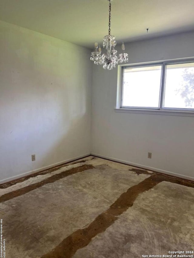 spare room with an inviting chandelier