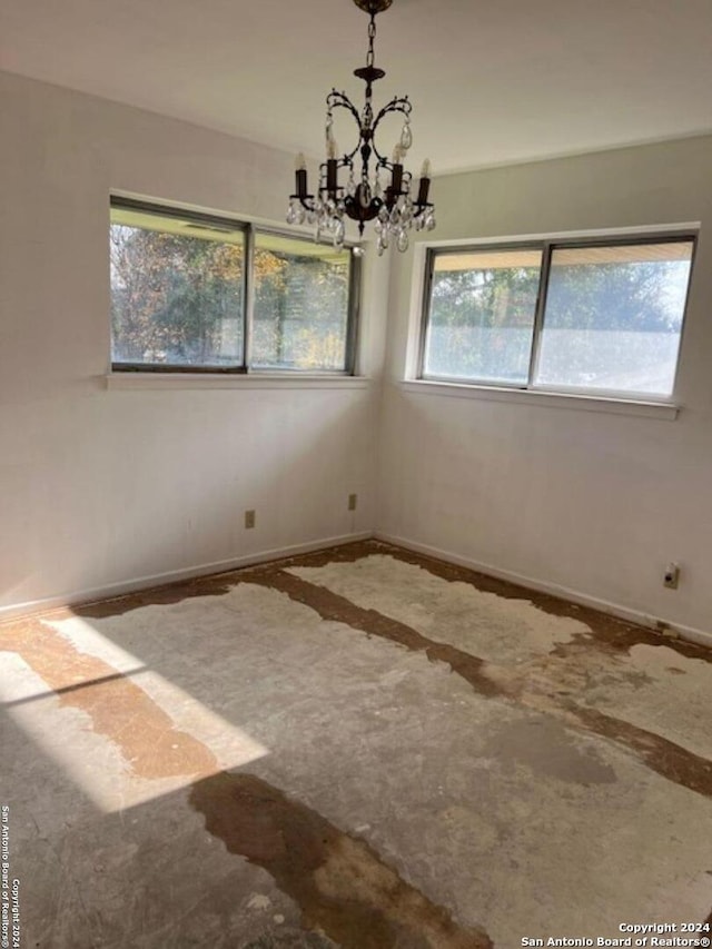 spare room with an inviting chandelier