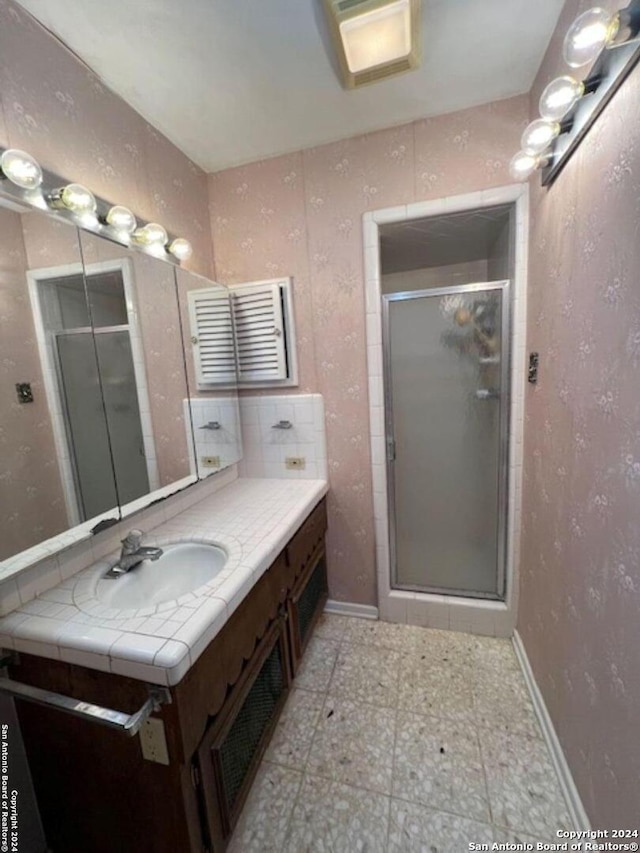 bathroom featuring vanity and walk in shower