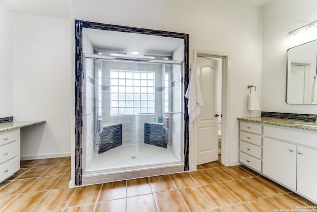 bathroom featuring hardwood / wood-style flooring, vanity, and an enclosed shower