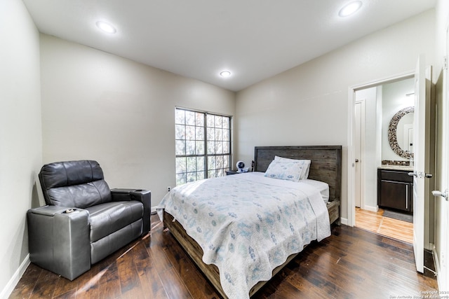 bedroom featuring dark hardwood / wood-style floors and ensuite bath