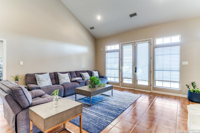 tiled living room with high vaulted ceiling