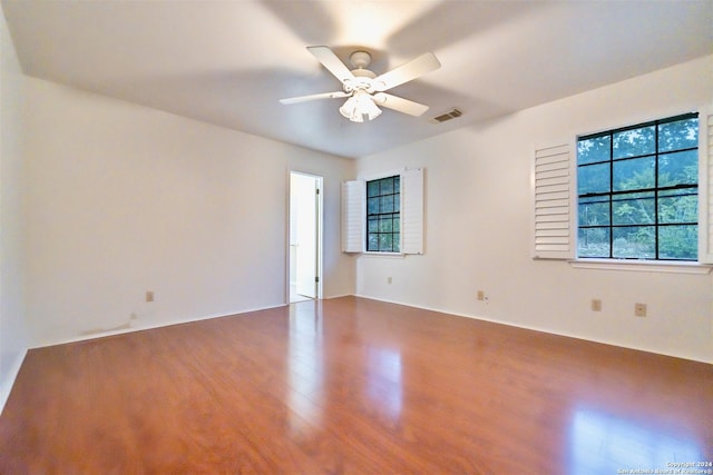 unfurnished room with ceiling fan and hardwood / wood-style flooring