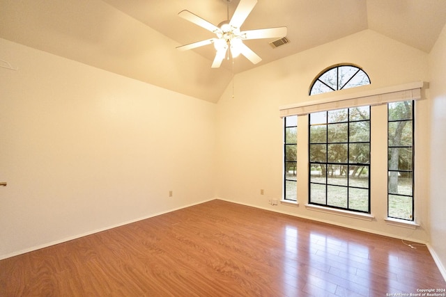 empty room featuring ceiling fan, wood-type flooring, and vaulted ceiling