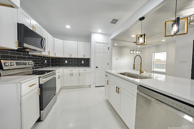 kitchen with sink, decorative light fixtures, stainless steel appliances, and white cabinets