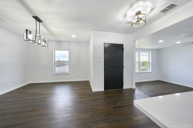 entryway with a textured ceiling and dark hardwood / wood-style flooring