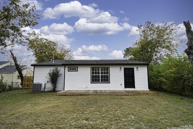 back of house featuring cooling unit and a lawn