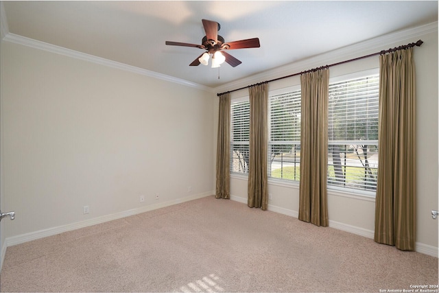 carpeted empty room featuring ceiling fan and crown molding