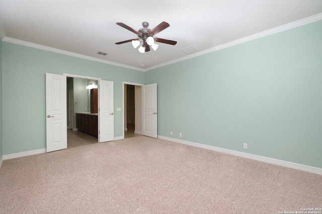 unfurnished bedroom featuring connected bathroom, ceiling fan, light colored carpet, and ornamental molding