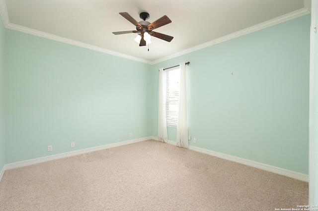 carpeted spare room featuring ceiling fan and ornamental molding