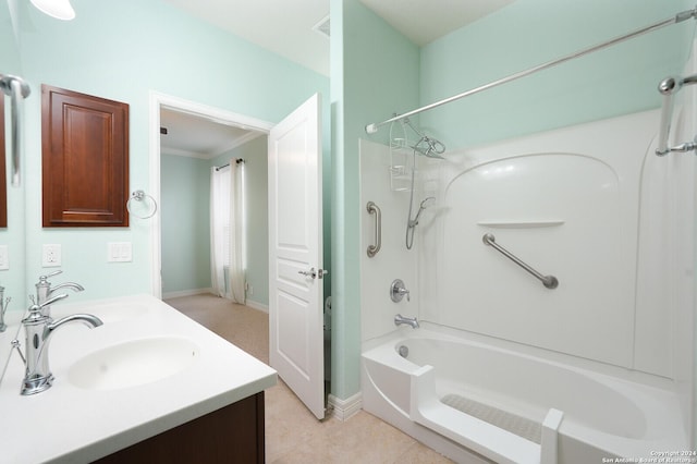 bathroom with tile patterned flooring, vanity,  shower combination, and crown molding