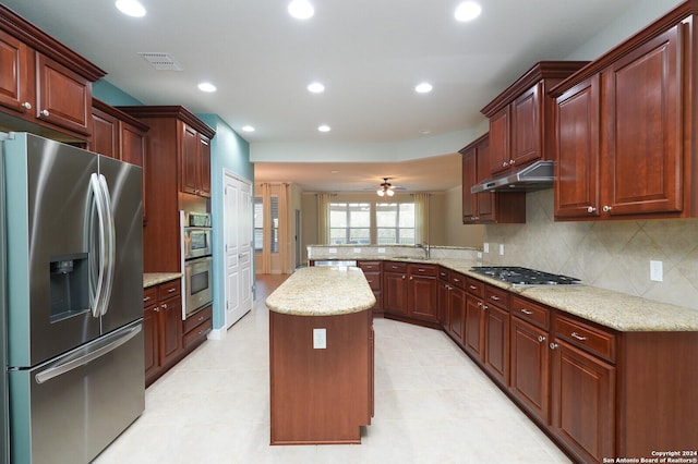 kitchen featuring sink, ceiling fan, appliances with stainless steel finishes, a kitchen island, and kitchen peninsula