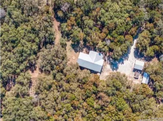 drone / aerial view featuring a wooded view