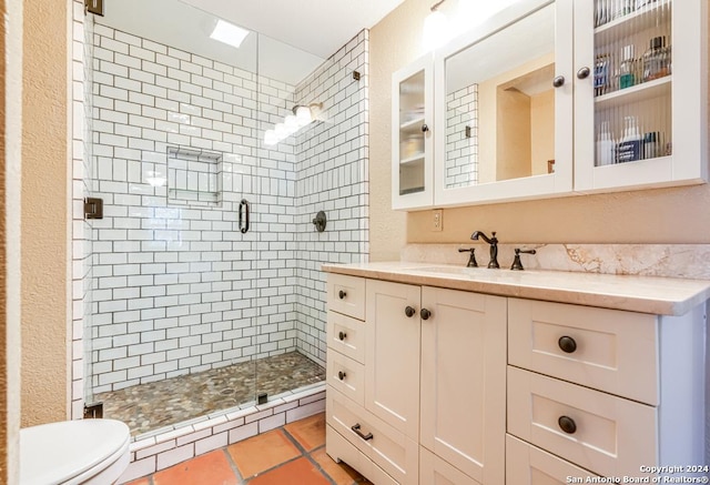 full bathroom with toilet, a stall shower, and vanity