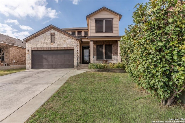 view of front of property featuring a front yard and a garage