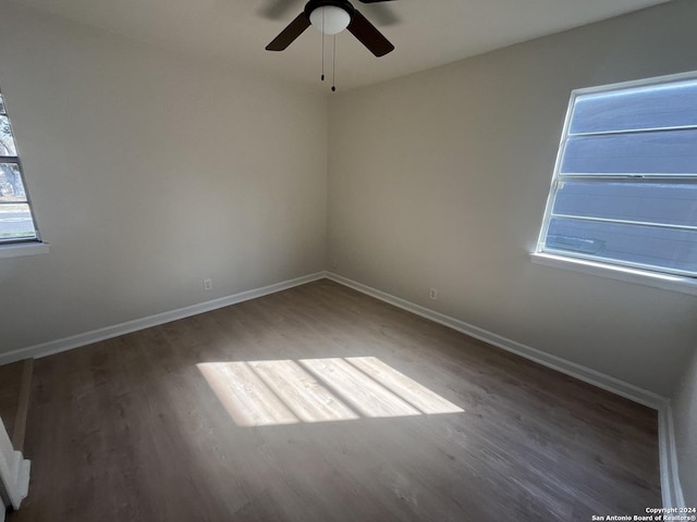 spare room featuring dark hardwood / wood-style flooring and ceiling fan