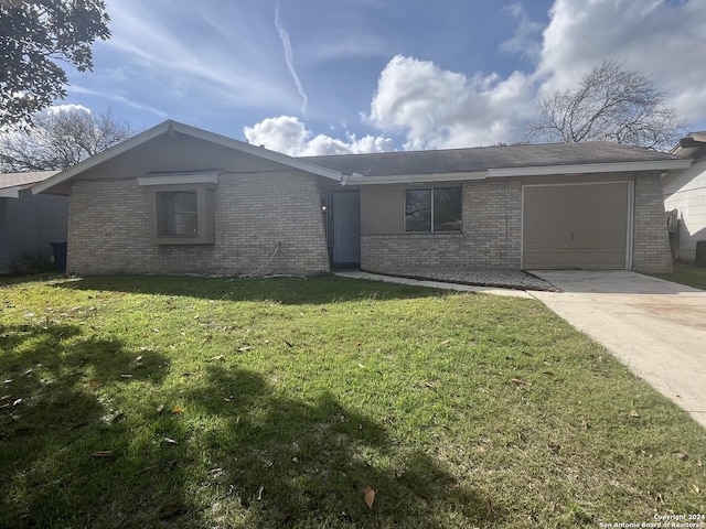 ranch-style home with a garage and a front lawn