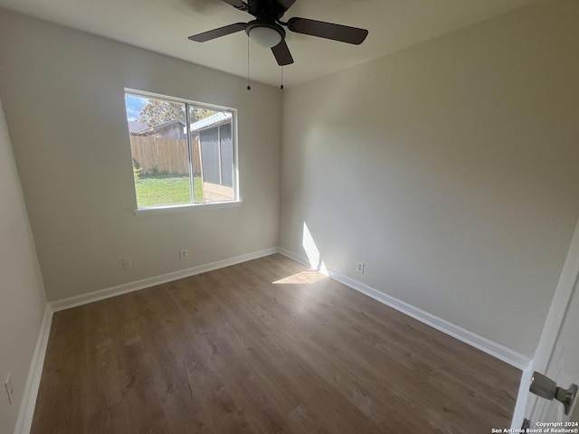 spare room featuring dark hardwood / wood-style floors and ceiling fan