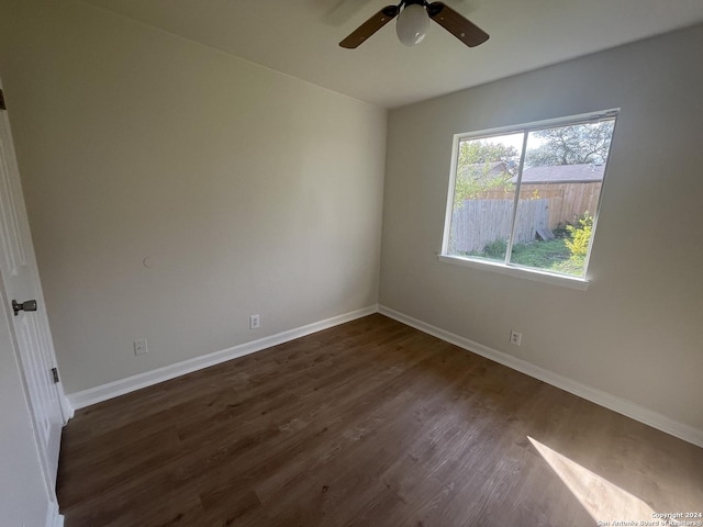 empty room featuring dark hardwood / wood-style flooring and ceiling fan