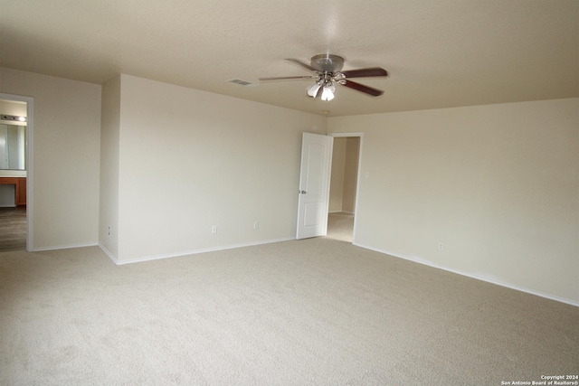 unfurnished room with ceiling fan and light carpet