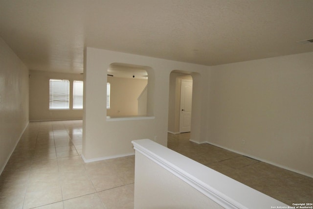 hallway with light tile patterned floors