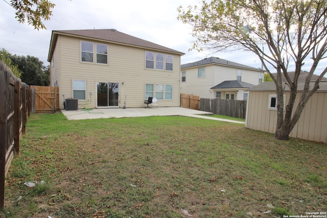 back of house with a yard, central AC, and a patio area