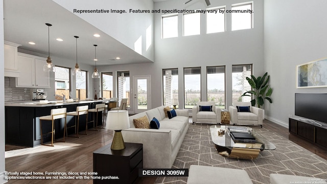 living room with a high ceiling and dark wood-type flooring