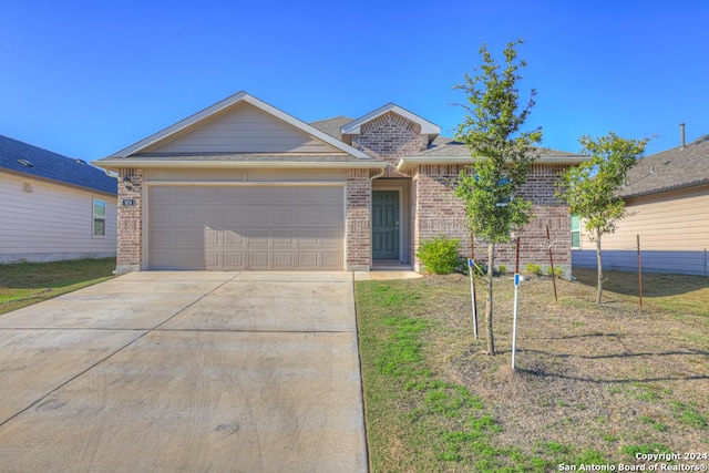 ranch-style home featuring a garage and a front lawn