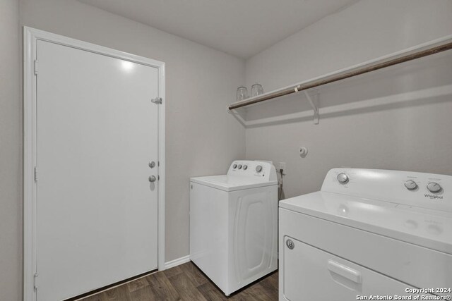 laundry room with washer and dryer and dark hardwood / wood-style floors