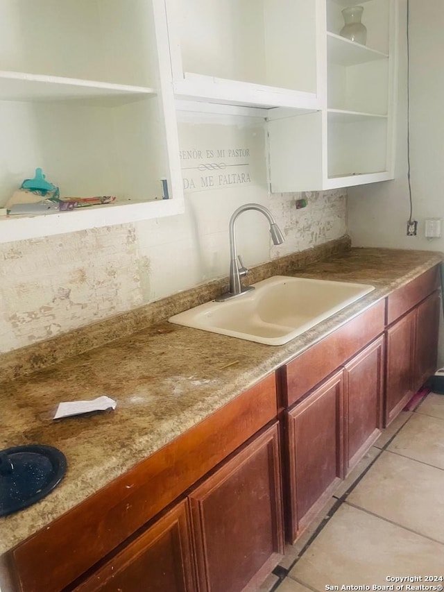 kitchen featuring sink and light tile patterned floors