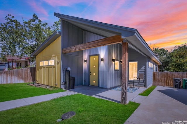 view of front facade featuring a yard and a patio area