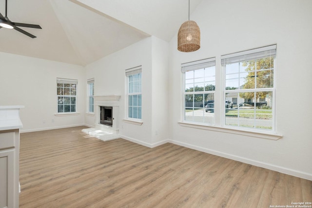 unfurnished living room featuring ceiling fan, light hardwood / wood-style floors, and high vaulted ceiling