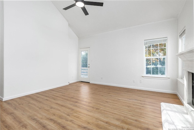 unfurnished living room with high vaulted ceiling, light hardwood / wood-style flooring, and ceiling fan