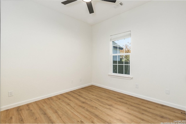 empty room with ceiling fan and light hardwood / wood-style floors