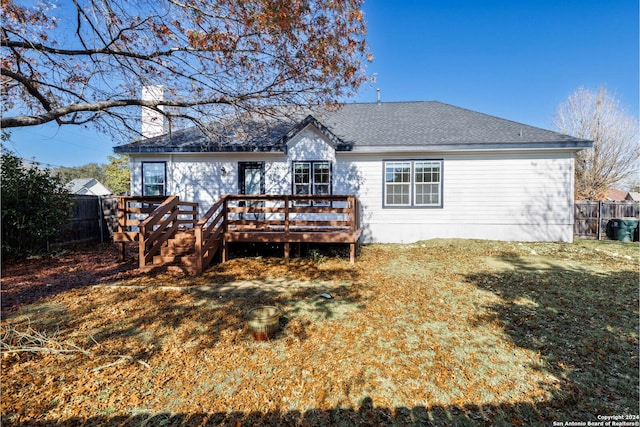 back of house with a lawn and a wooden deck