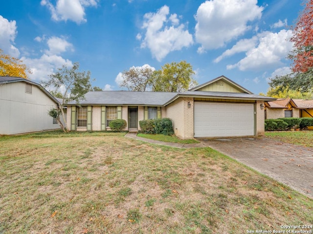 ranch-style home with a front yard and a garage