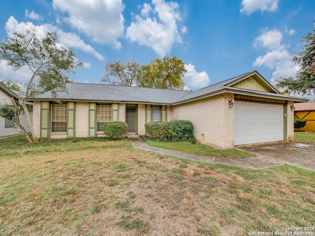 single story home featuring a garage and a front yard