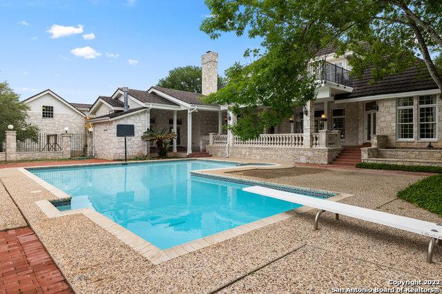 view of swimming pool featuring a diving board and a patio area