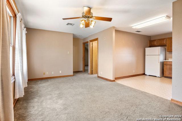 carpeted empty room with ceiling fan