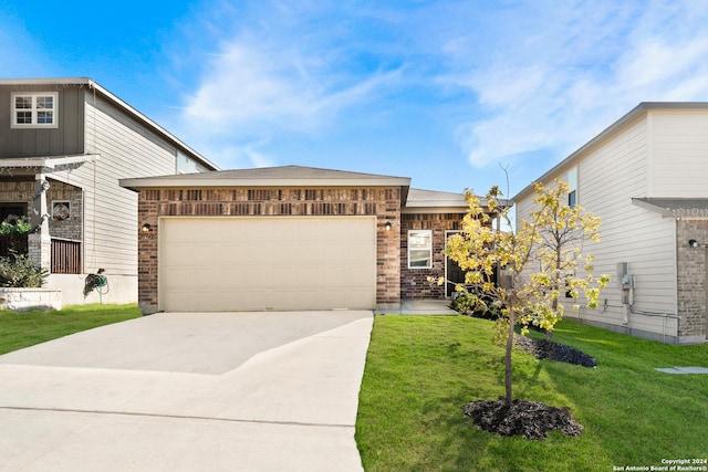 view of front of house with a front yard and a garage