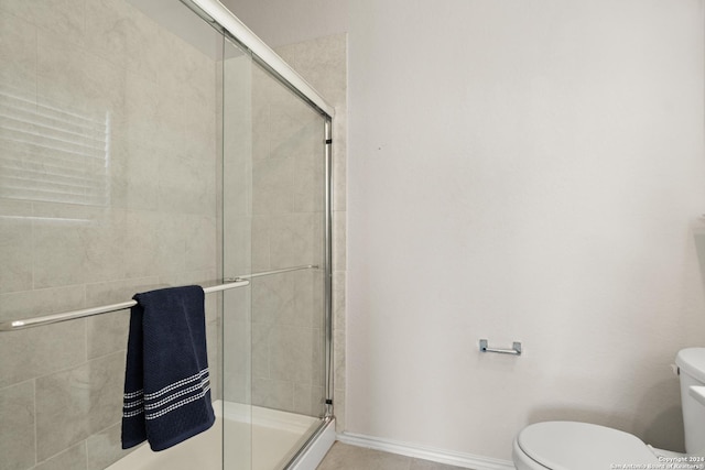 bathroom featuring an enclosed shower and toilet