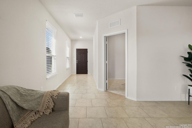 corridor with light tile patterned flooring