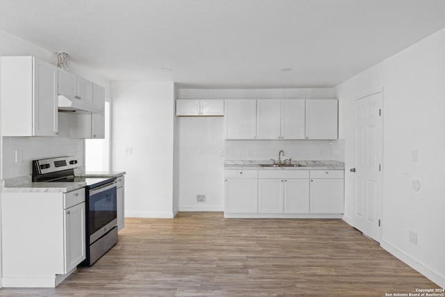 kitchen with white cabinetry, sink, stainless steel range with electric cooktop, and light wood-type flooring