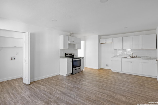 kitchen with white cabinets, light hardwood / wood-style flooring, stainless steel range with electric cooktop, and sink