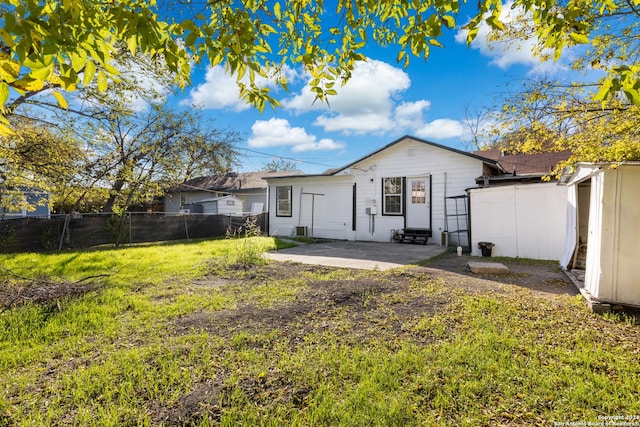 back of property featuring a yard and a patio