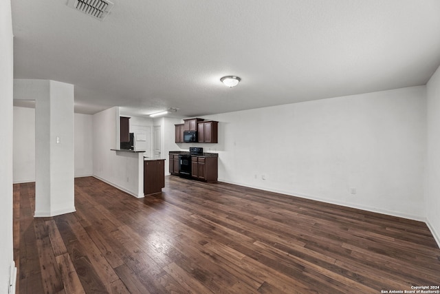 unfurnished living room featuring a textured ceiling and dark wood-type flooring