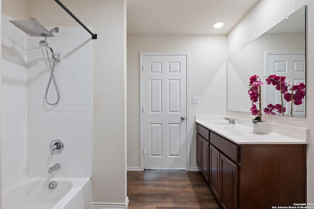 bathroom with vanity, wood-type flooring, and tiled shower / bath combo